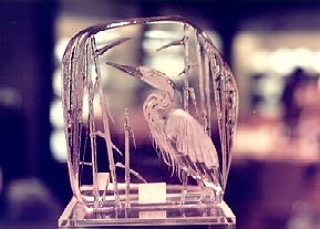 slab of glass with swan carved in it